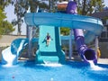 Happy teenage girl going down by water slide into the pool Royalty Free Stock Photo