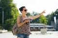 Happy teenage girl with guidebook and backpack