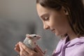 Happy teenage girl holding small domesticated rat in hands, closeup Royalty Free Stock Photo