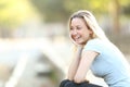 Happy teenage girl laughing looking away in a park Royalty Free Stock Photo