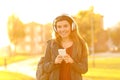 Happy teenage girl listening to music looking at you Royalty Free Stock Photo