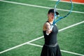 Happy teenage girl looking at her tennis racket with scarlet heart Royalty Free Stock Photo