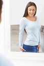 Happy Teenage Girl Looking At Reflection In Mirror Royalty Free Stock Photo