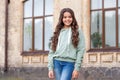 Happy teenage girl model posing in casual trendy style blurry outdoors, fashion Royalty Free Stock Photo