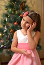 Happy teen girl near decorated Christmas tree Royalty Free Stock Photo