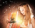 A happy teenage girl opening a Christmas present Royalty Free Stock Photo