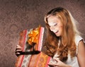 A happy teenage girl opening a Christmas present Royalty Free Stock Photo