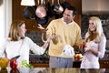 Happy teenage girl and parents chatting in kitchen Royalty Free Stock Photo