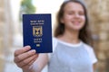 Happy teenage girl showing the passport of the State of Israel holding it in hand Royalty Free Stock Photo