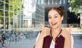 happy teenage girl showing thumbs up in city Royalty Free Stock Photo