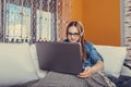 Happy teenage girl using laptop and listening music with headphones Royalty Free Stock Photo