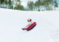 Happy teenage girl sliding down on snow tube Royalty Free Stock Photo