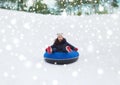 Happy teenage girl sliding down on snow tube Royalty Free Stock Photo