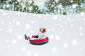 Happy teenage girl sliding down on snow tube Royalty Free Stock Photo