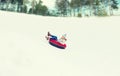 Happy teenage girl sliding down on snow tube Royalty Free Stock Photo