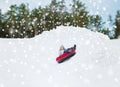 Happy teenage girl sliding down on snow tube