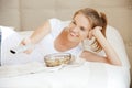 Happy teenage girl with TV remote and popcorn Royalty Free Stock Photo