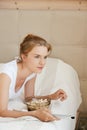 Happy teenage girl with TV remote and popcorn Royalty Free Stock Photo