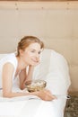 Happy teenage girl with TV remote and popcorn Royalty Free Stock Photo