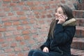 Teenage girl talking on the smartphone outside