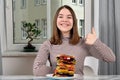 Teenage girl with vegan sandwich and thumb up