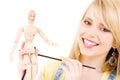 Happy teenage girl with wooden model dummy Royalty Free Stock Photo