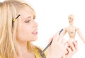 Happy teenage girl with wooden model dummy Royalty Free Stock Photo