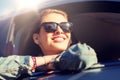 Happy teenage girl or young woman in car Royalty Free Stock Photo