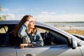 Happy teenage girl or young woman in car Royalty Free Stock Photo