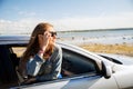 Happy teenage girl or young woman in car Royalty Free Stock Photo