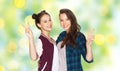 Happy teenage girls hugging and showing peace sign Royalty Free Stock Photo