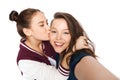 Happy teenage girls taking selfie and kissing Royalty Free Stock Photo