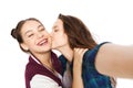 Happy teenage girls taking selfie and kissing Royalty Free Stock Photo