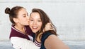 Happy teenage girls taking selfie and kissing Royalty Free Stock Photo