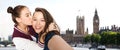 Happy teenage girls taking selfie in london Royalty Free Stock Photo