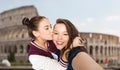 Happy teenage girls taking selfie over coliseum Royalty Free Stock Photo