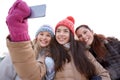 Happy teenage girls taking selfie with smartphone Royalty Free Stock Photo