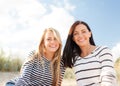 Happy teenage girls or young women on beach Royalty Free Stock Photo
