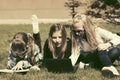 Happy teenage school girls lying on a grass in campus Royalty Free Stock Photo