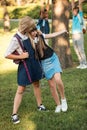 Schoolgirls with backpacks in park