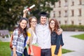 Happy teenage students with diploma and folders Royalty Free Stock Photo