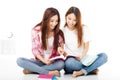 Happy teenage students girls watching the books