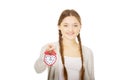 Happy teenage woman with alarmclock. Royalty Free Stock Photo