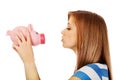 Happy teenage woman kissing a piggybank Royalty Free Stock Photo