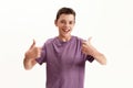 Happy teenaged disabled boy with cerebral palsy smiling at camera and showing thumbs up with both hands, posing isolated Royalty Free Stock Photo