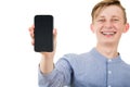 Happy teenager boy showing his smartphone blank screen isolated over white background. Joyful adolescent guy presenting a new Royalty Free Stock Photo