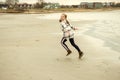 Happy teenager child girl walking and playing on Baltic sea beach