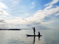 Happy teenager children in swimsuits  having fun on SUP board and  paddling in sea Royalty Free Stock Photo