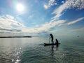 Happy teenager children in swimsuits  having fun on SUP board and  paddling in sea Royalty Free Stock Photo