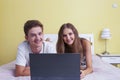 Happy teenager girl and boy watching a laptop Royalty Free Stock Photo